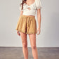 Beige linen shorts with fringe hem and tassel drawstring