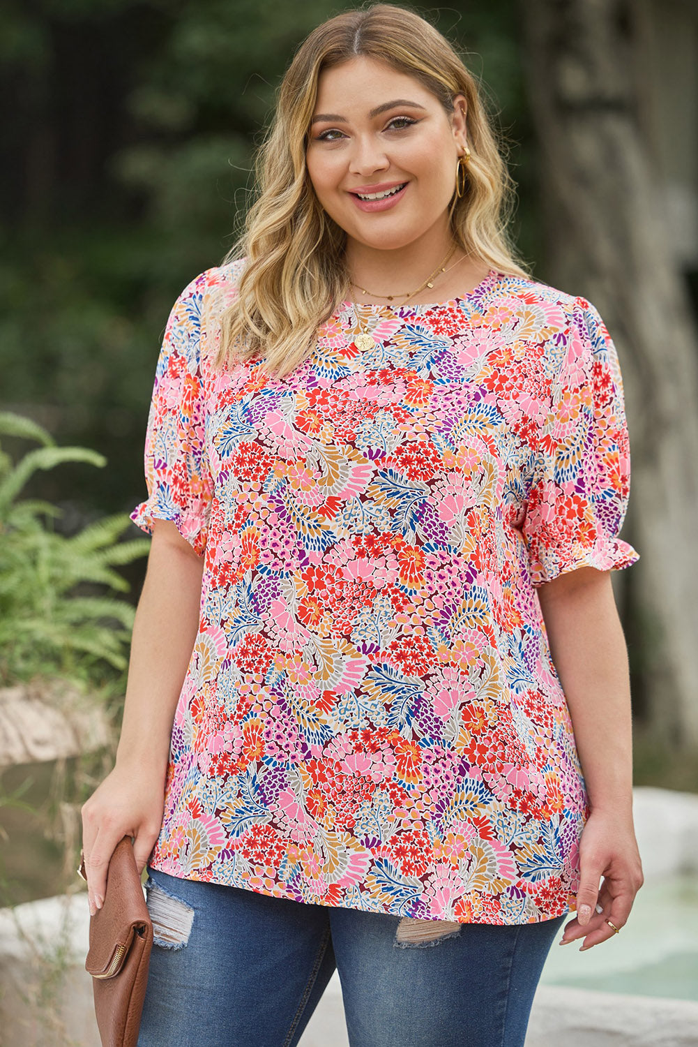 Detailed view of the beautiful floral design on a summer-ready, versatile women's top