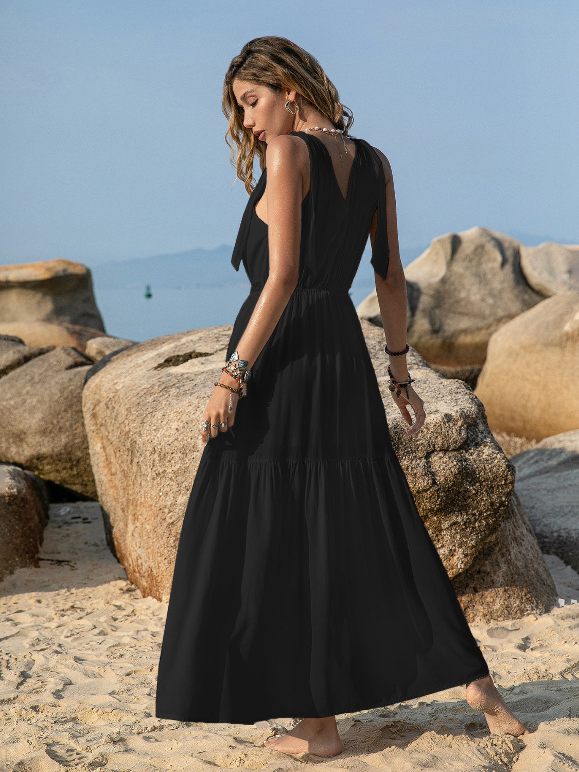 Elegant V-Neck Maxi Dress with tie shoulders and crochet waist, available in white, green, and black. Perfect for any sophisticated occasion.