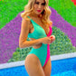 Stylish one-piece swimsuit with flattering side cutouts in bold aqua and hot pink colors.