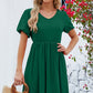 Green V-neck dress with puff sleeves and a flared skirt.