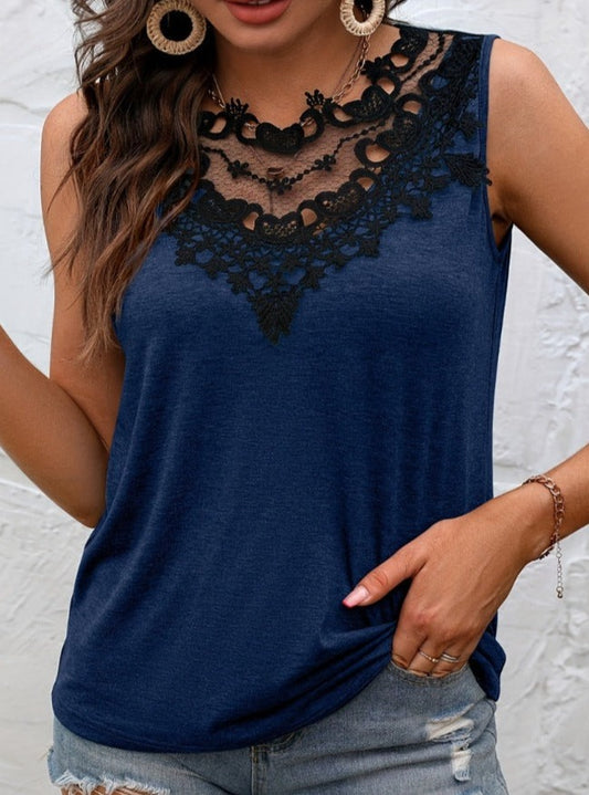 Stylish dark blue sleeveless top with delicate black lace neckline, paired with distressed denim shorts for a chic summer look