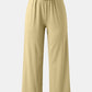High-waisted wide-leg pants with a drawstring tie in multiple colors.