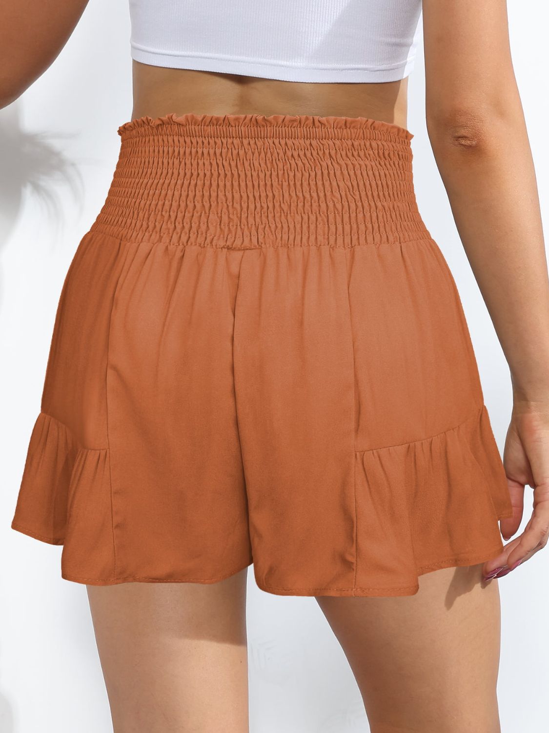 Chic terracotta high-rise shorts with a flattering smocked waistband and tie-front. Perfect for a stylish, comfy summer look.