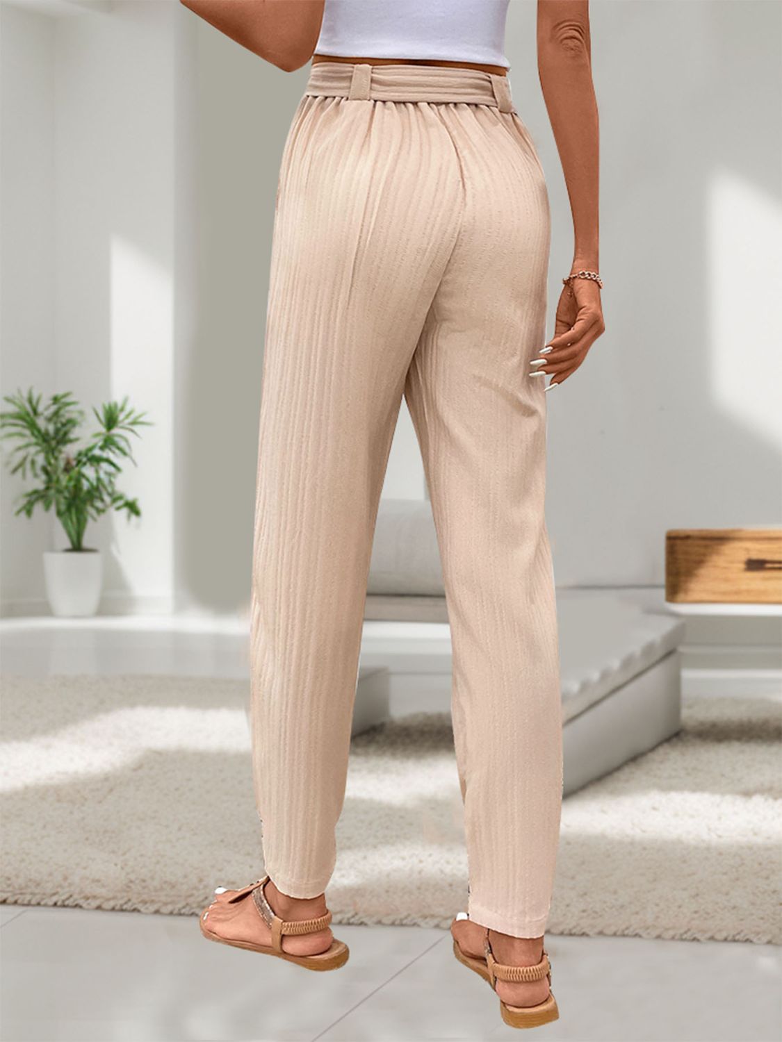 Breathable beige drawstring pants with a relaxed fit and stylish design.