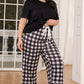 Lounge in style with our V-Neck Tee & Plaid Cropped Pants Set. Perfect blend of comfort and chic for everyday wear