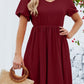 Wine V-neck dress with puff sleeves and a flared skirt.