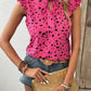 Chic fuchsia tie-neck blouse with playful prints, perfect for summer. Flattering fit, easy to style, and breezy for warm days