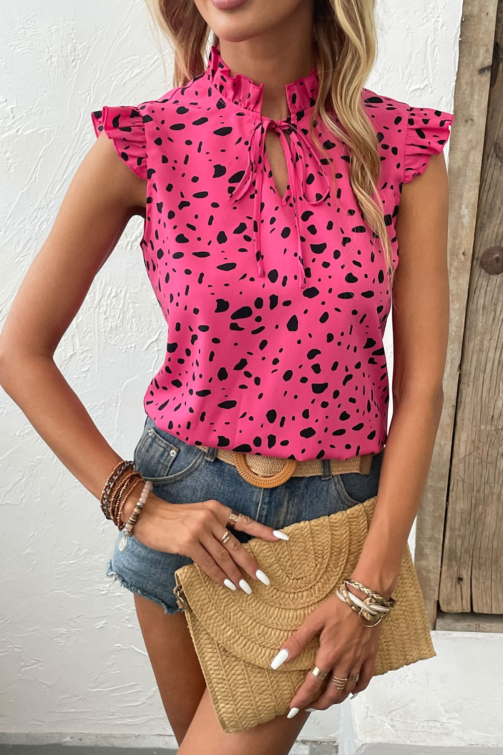 Chic fuchsia tie-neck blouse with playful prints, perfect for summer. Flattering fit, easy to style, and breezy for warm days