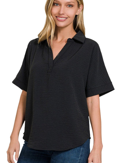 Short sleeve black blouse with a stylish collar and relaxed design