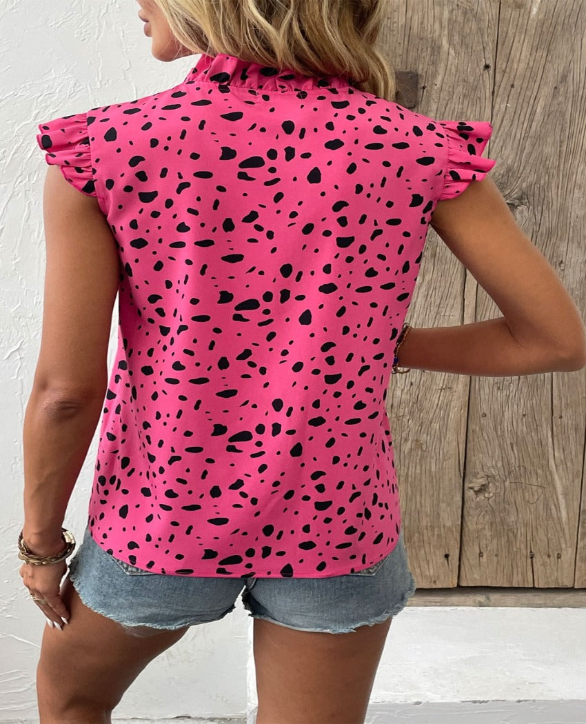 Chic fuchsia tie-neck blouse with playful prints, perfect for summer. Flattering fit, easy to style, and breezy for warm days