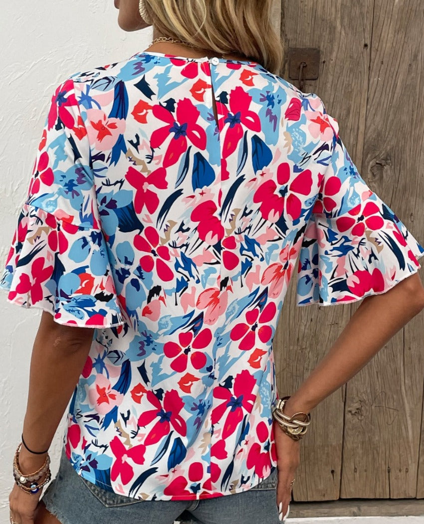 Flaunt style with our Printed Blouse featuring flounce sleeves, a round neck, and vibrant hues perfect for any occasion. Shop now!