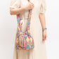 Multi-colored boho bucket bag with intricate patterns and tassels.