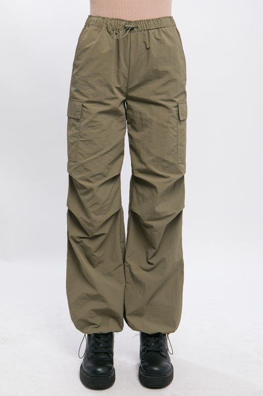 Women’s olive cargo pants featuring drawstring waist, perfect for everyday wear.
