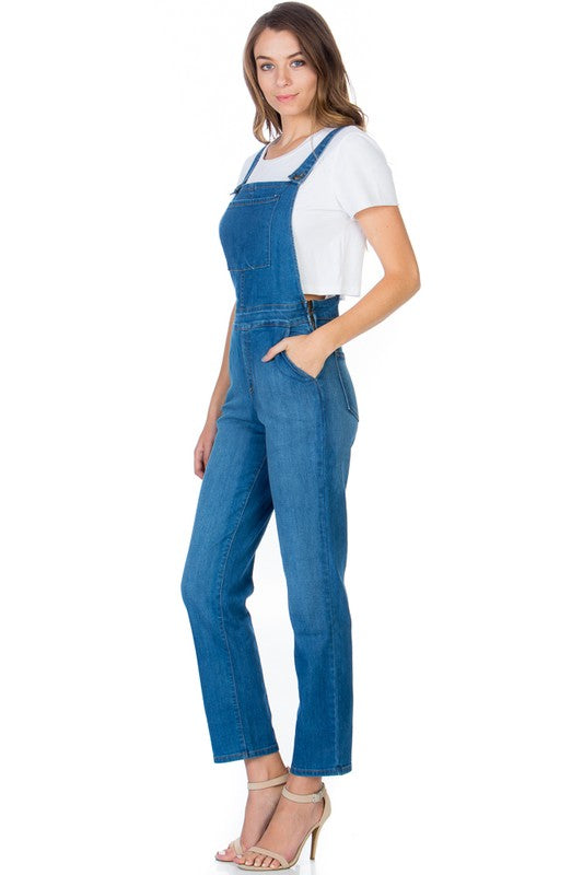 Front view of women’s adjustable strap denim overalls in medium wash.
