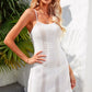 White bathing suit cover up with crisscross straps and halter neck