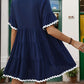 Short-sleeve navy blue dress with white ruffle accents
