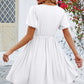 White V-neck dress with puff sleeves and a flared skirt.