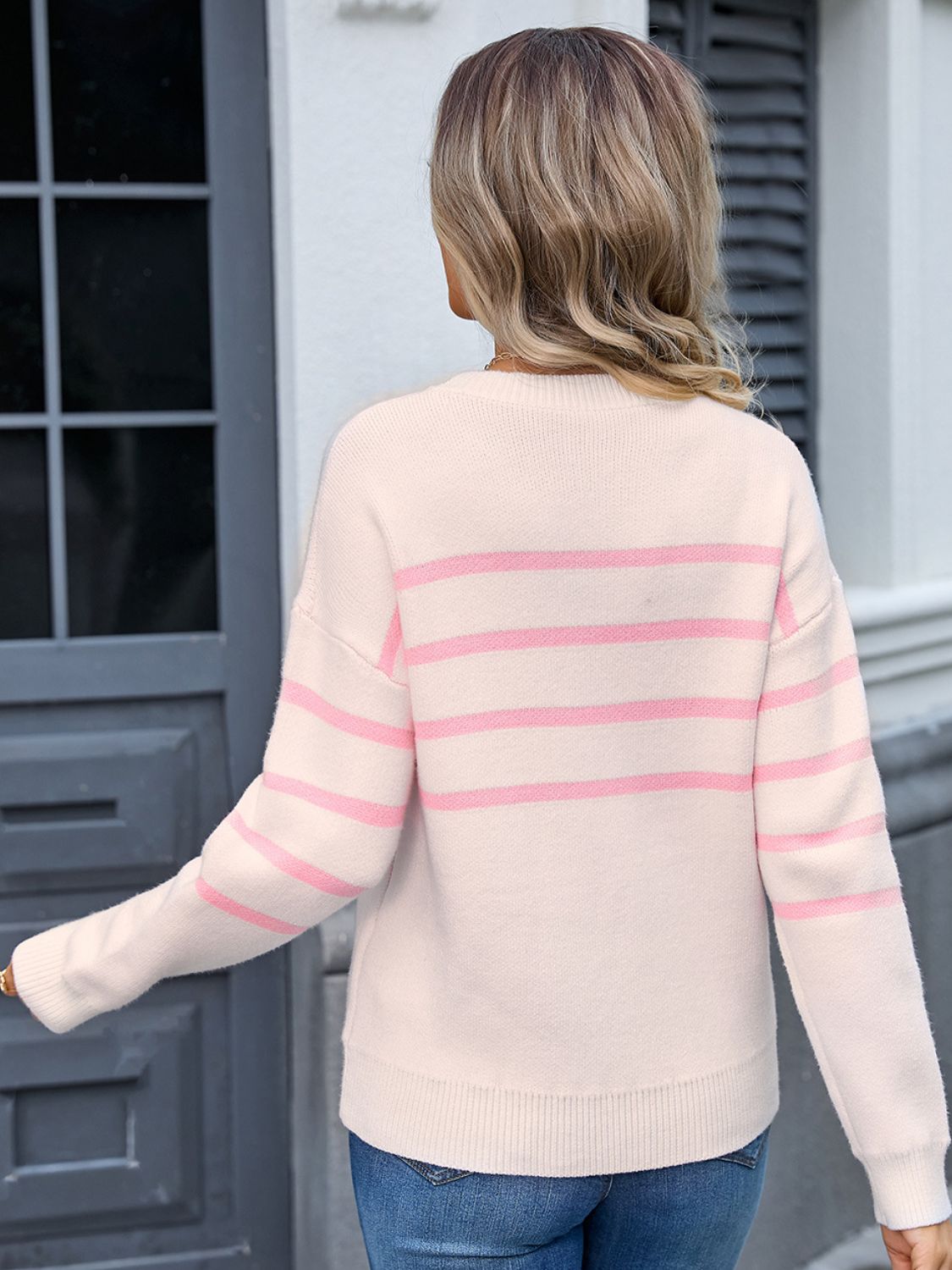 Back view of pink Angel Wings sweater with delicate stripes and bow detail
