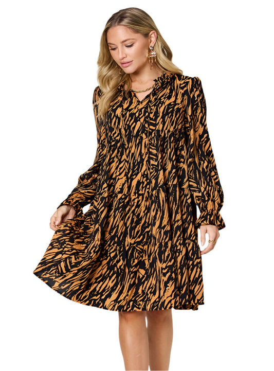 Black-and-gold animal print tiered dress with long sleeves and ruffled V-neckline.
