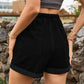 Chic high-waist denim shorts with a comfortable drawstring, roomy pockets, and a versatile roll-up hem for the perfect summer look