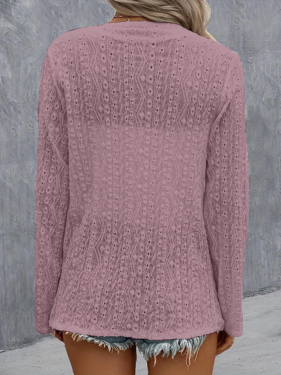 Versatile pink cardigan with roll-up sleeves.