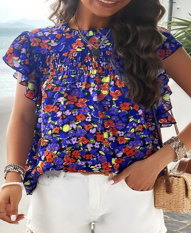 Embrace spring with this floral Smocked Mock Neck Blouse. Perfect for any occasion, available in 5 colors for a fresh, stylish look