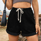 Chic high-waist denim shorts with a comfortable drawstring, roomy pockets, and a versatile roll-up hem for the perfect summer look