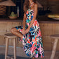 Side view of a floral print maxi dress with tie straps and a flowing design.