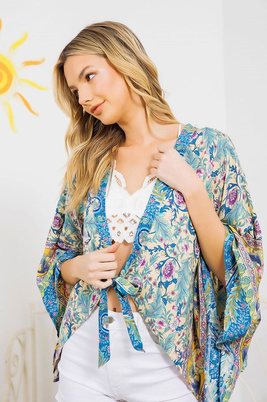 Breezy turquoise kimono with colorful floral print.