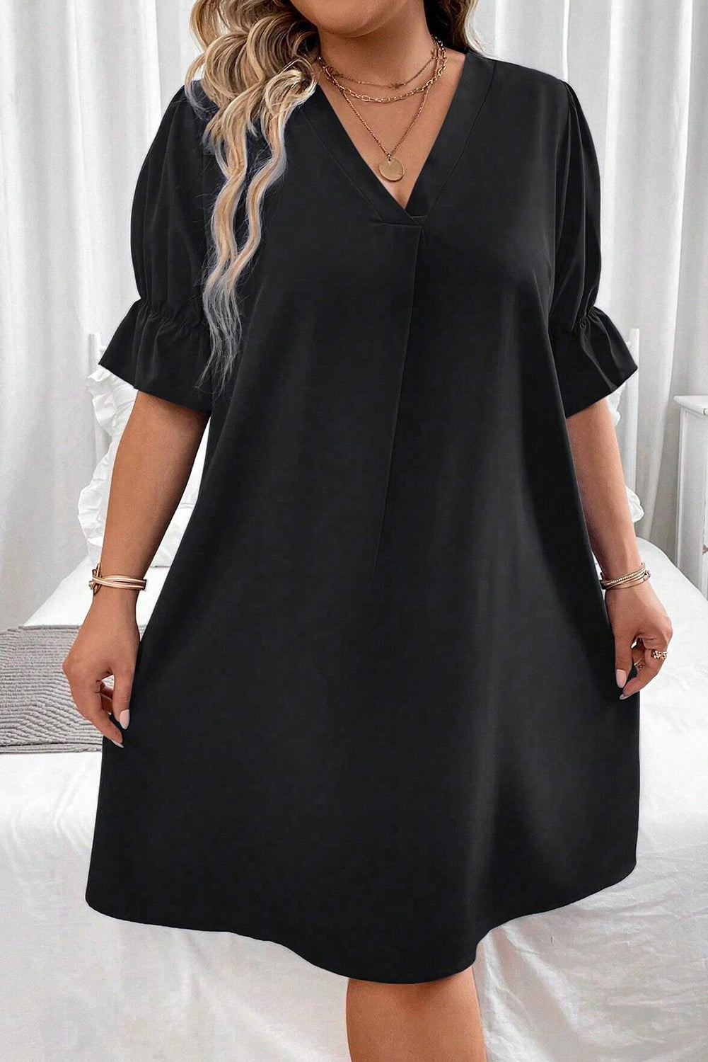 Elevate your style with our Plus Size Mini Dress featuring a chic V-neck and ruffled puff sleeves for a flattering, fashionable look.