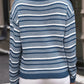 Back view of the cozy blue and white striped round-neck sweater, showing its relaxed fit and long sleeves.

