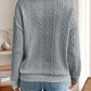 Back view of a gray quarter-zip knit sweater, featuring a relaxed fit and soft knit fabric.

