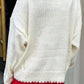 Back view of a white knit sweater featuring an oversized bow, perfect for casual winter days.

