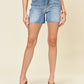 Rock your look with Judy Blue's Full Size High Waist Raw Hem Denim Shorts, blending edgy style and comfort for a standout summer ensemble