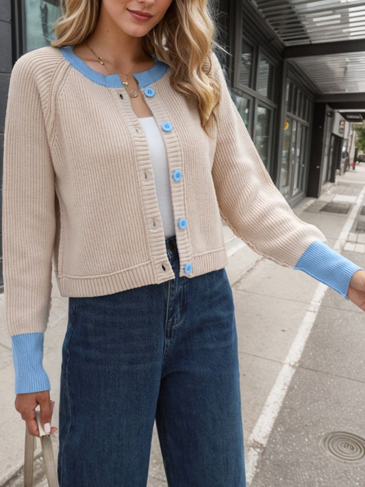 Cozy beige cardigan featuring blue contrast trim, made from soft fabric for comfortable wear.