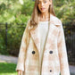 Beige fuzzy boucle coat for women, styled with a casual outfit for a cozy look.
