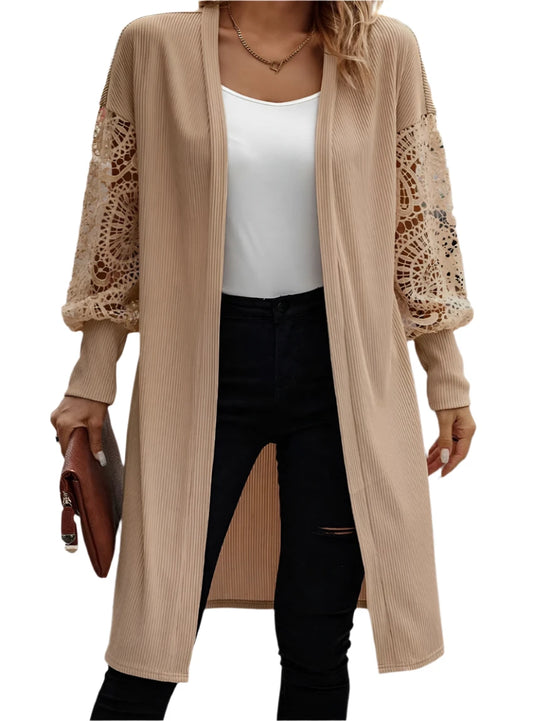 Woman wearing a beige lantern sleeve cardigan, front view
