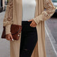 Detailed texture shot of the ribbed knit and lace sleeve on beige cardigan