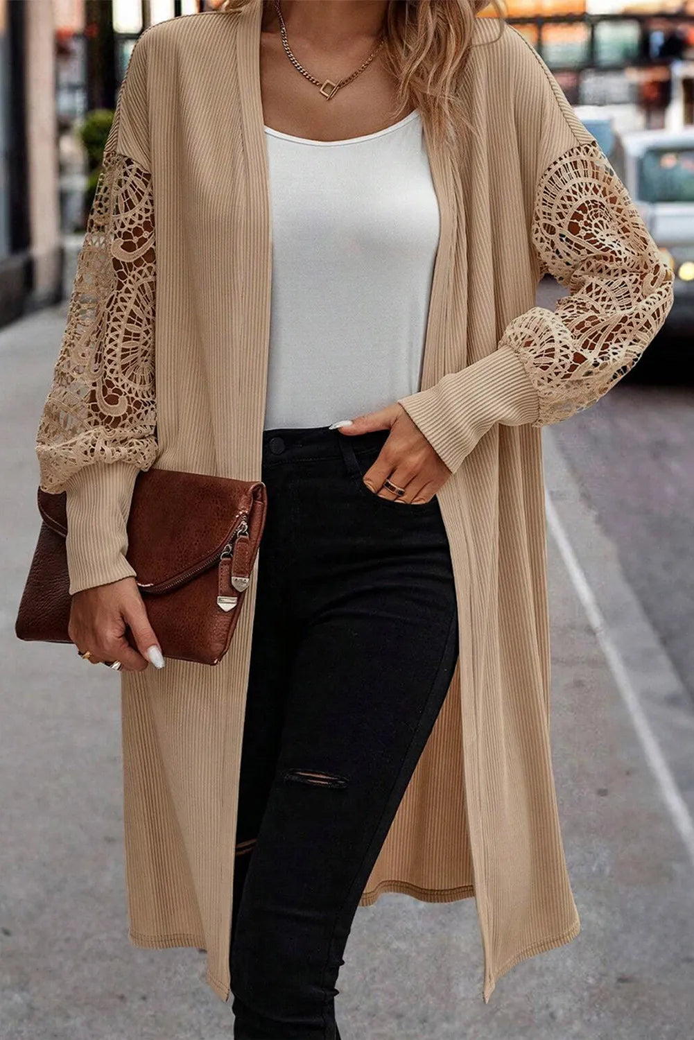 Detailed texture shot of the ribbed knit and lace sleeve on beige cardigan