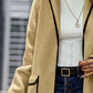 Beige long sherpa coat with contrast detailing for a contemporary look.
