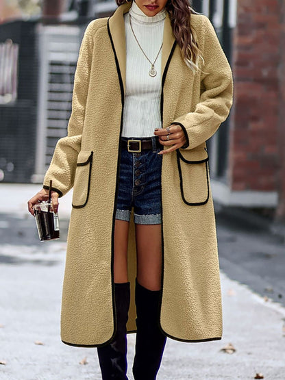 Stylish winter wear: beige long sherpa coat with black trim detail.
