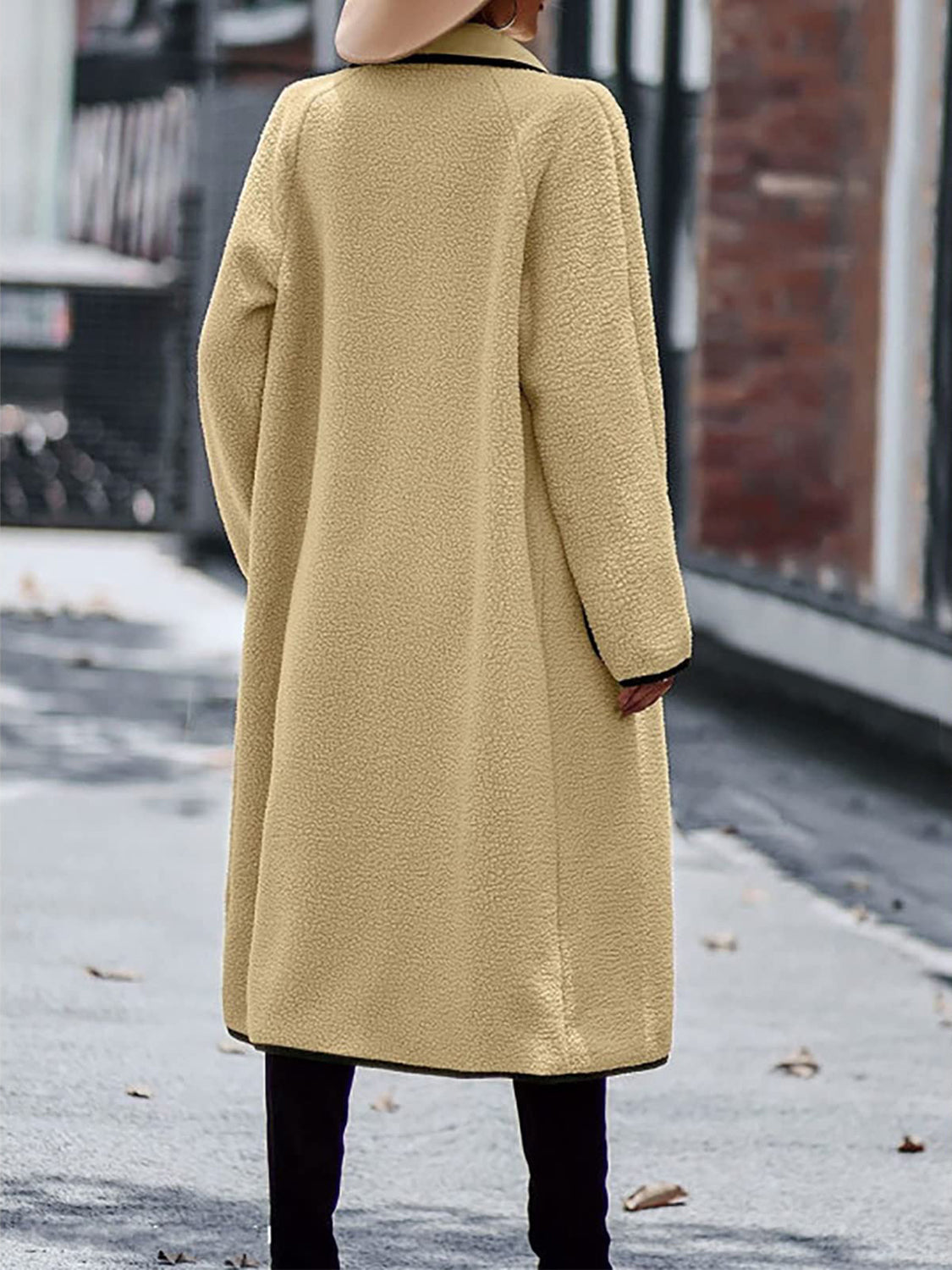 Stylish winter wear: beige long sherpa coat with black trim detail.
