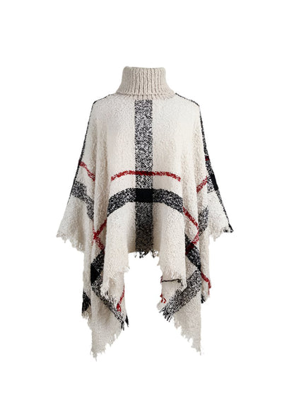 Women’s beige plaid turtleneck fringe poncho, front view.
