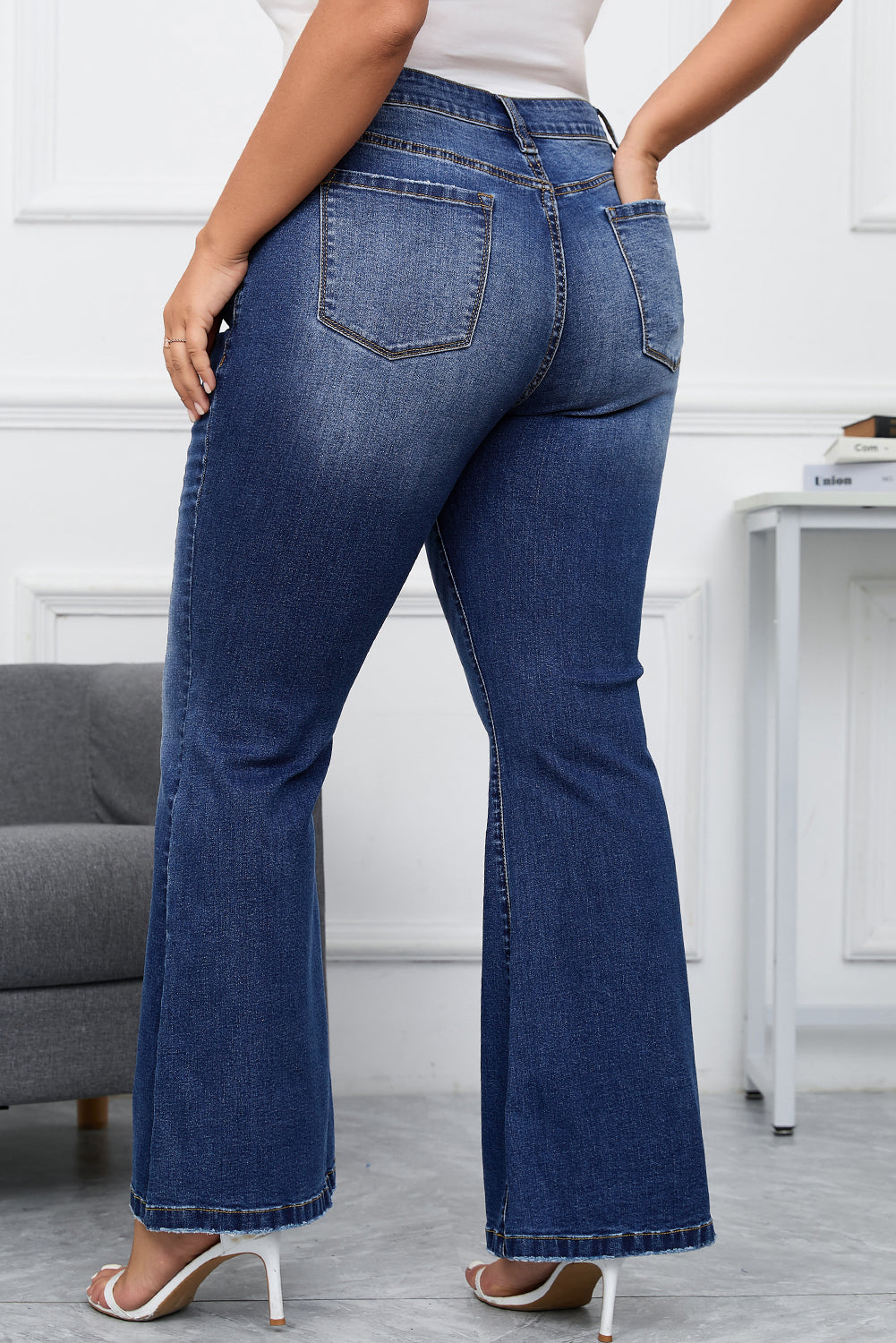 Dark wash vintage style flare jeans for plus size with a high-rise waist.
