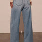 Back view of light wash high-waist wide-leg jeans featuring a relaxed wide-leg design.
