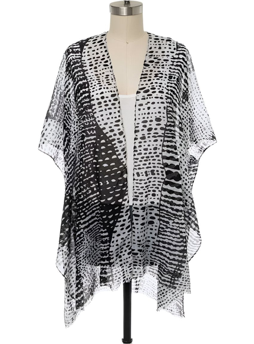 Front view of a black and white dots kimono cardigan with an open front.
