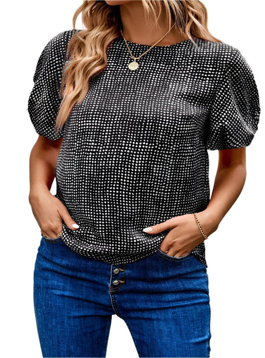 Stylish black and white polka dot blouse paired with high-waisted jeans for a casual look