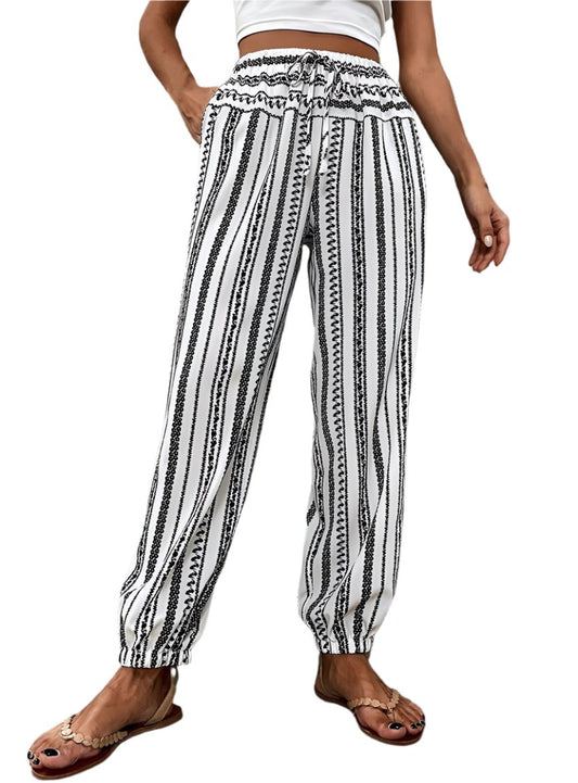 Women's black and white striped jogger pants with elastic waist and cuffs.