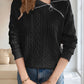 Front view of a black cable knit quarter-zip sweater, ideal for cool weather styling and comfort.

